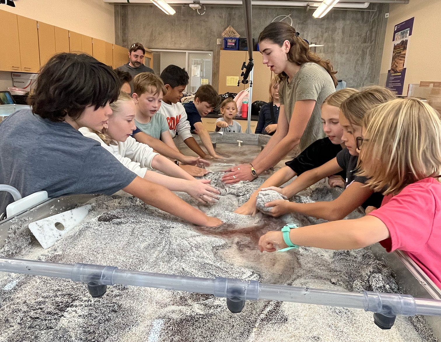 Kiri teaching 4th grades how to use the stream table.